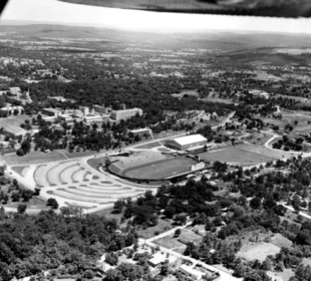 An aerial view of Razorback Stadium, circa 1955. At the south end of the stadium is Barnhill Field House (later Barnhill Arena), which opened a year earlier.