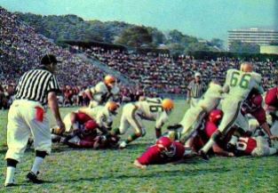 Arkansas in action during the 1964 season. At that time, Razorback Stadium's construction allowed fans a spectacular view of the Ozarks. Meanwhile, residents of Reid Hall could watch games from their dorm room.