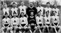 In the decade following the foundation of the Southwest Conference in 1915, Texas and Texas A&M combined to win nine league titles in basketball. But in only their third season of competition, the Razorbacks captured the 1926 SWC championship in dominating fashion. Guided by Schmidt, standing in the middle of the back row, Arkansas posted a 23-2 record -- going 11-1 in the SWC -- and went 4-0 against Texas and Texas A&M. Schmidt was also grooming his protege: standing to his right is Glen Rose, who would return in 1934 lift his alma mater to even greater heights.